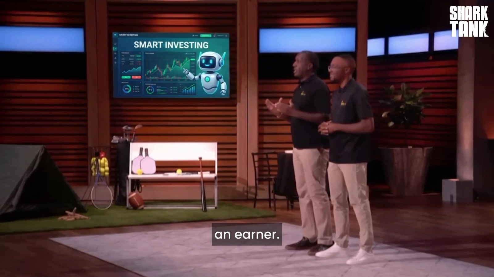 Bot-It founders on stage in Shark Tank in front of a Smart Investing dashboard